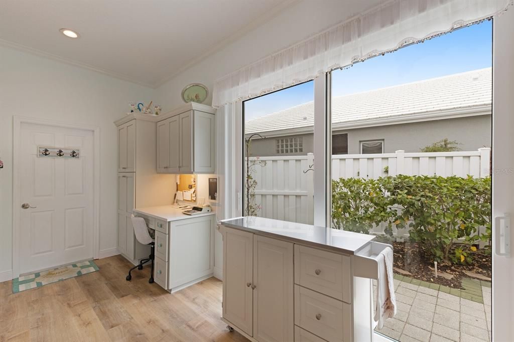 Built-in desk near garage entry and walk-in pantry to the left