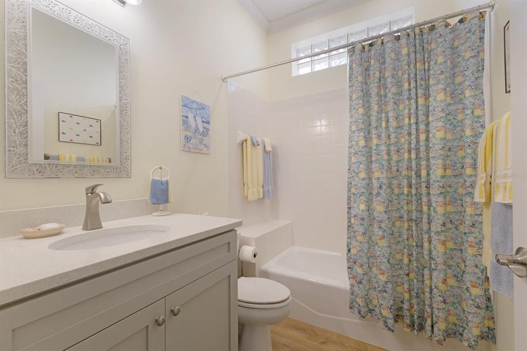 New vanity with quartz countertops in guest bathroom