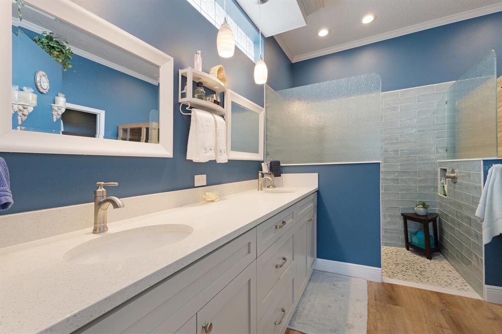 Renovated ensuite primary bathroom with quartz counter tops