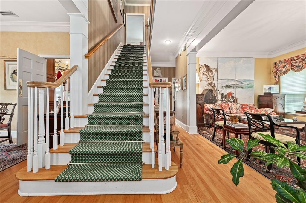 Center hall staircase with Living room to right and dining room to left of foyer