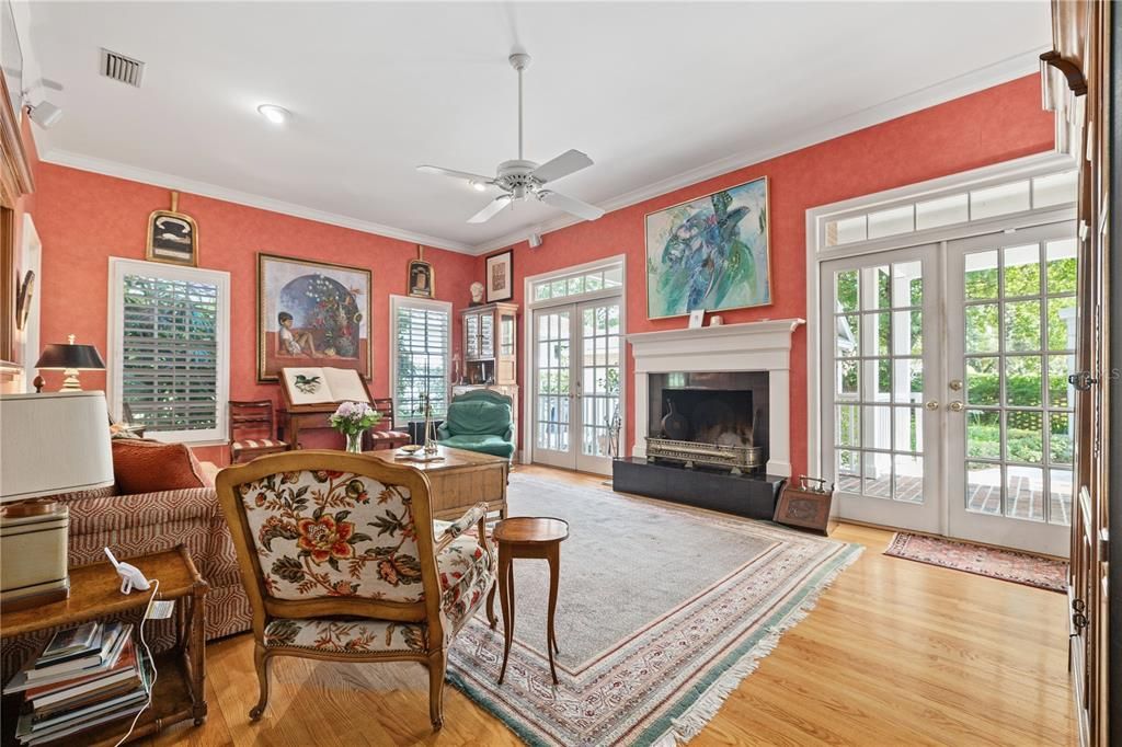 Sunny family room with fireplace overlooking back yard