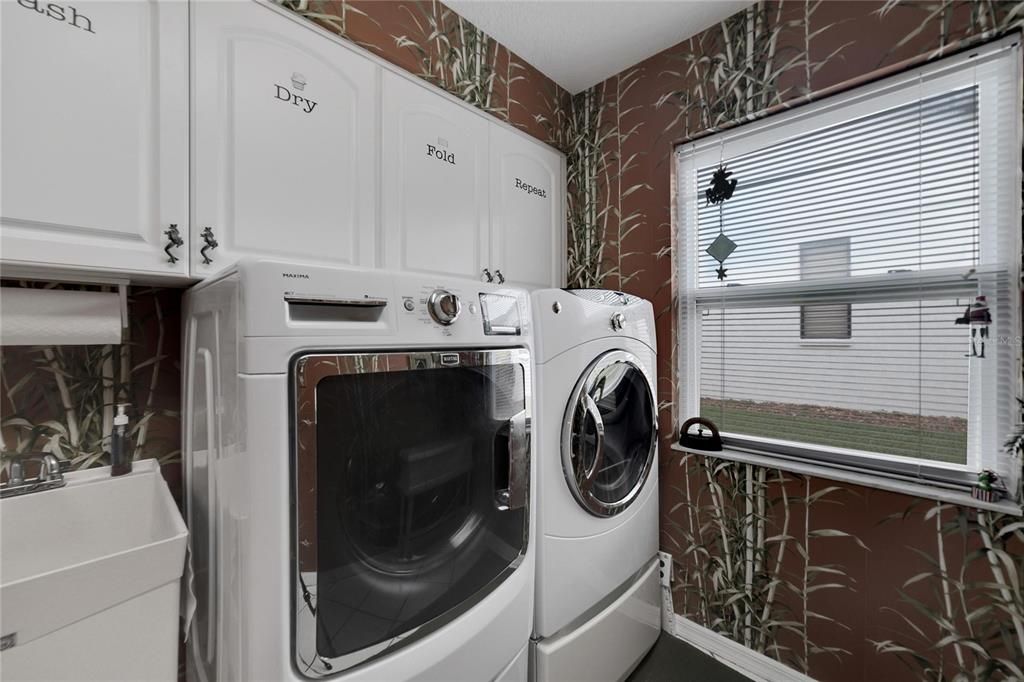 laundry with cabinets/sink washer and dryer included