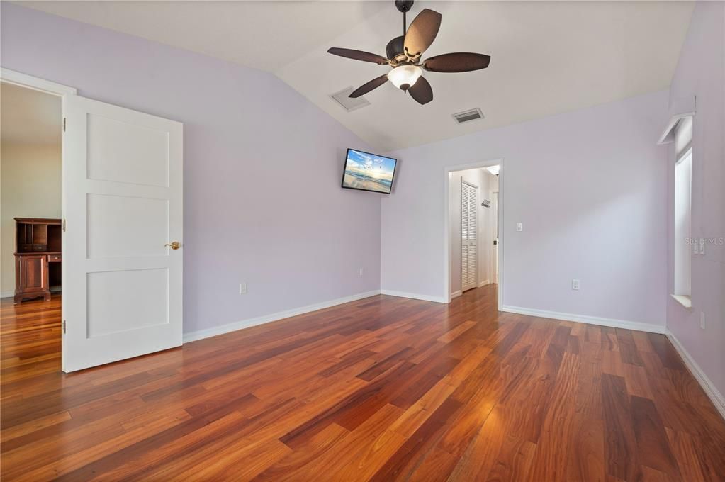 Primary Bedroom. Watch tv from your bed. Two walk-in closets flank hallway on way to master bathroom.