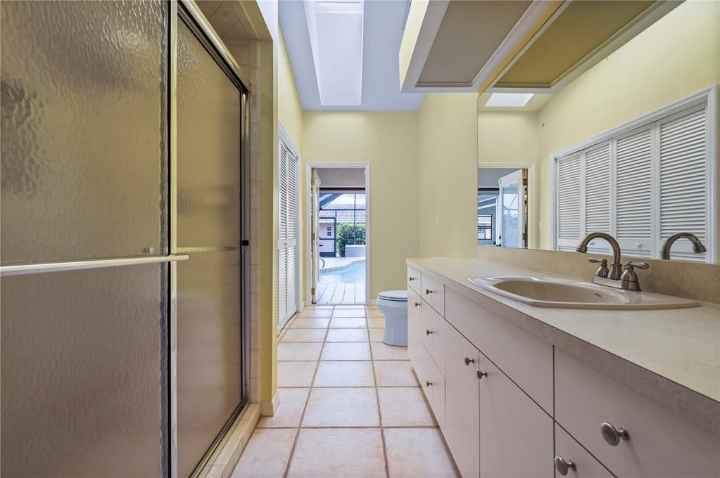 Second Bathroom, also serves as pool bath. Skylight in the vaulted ceiling.