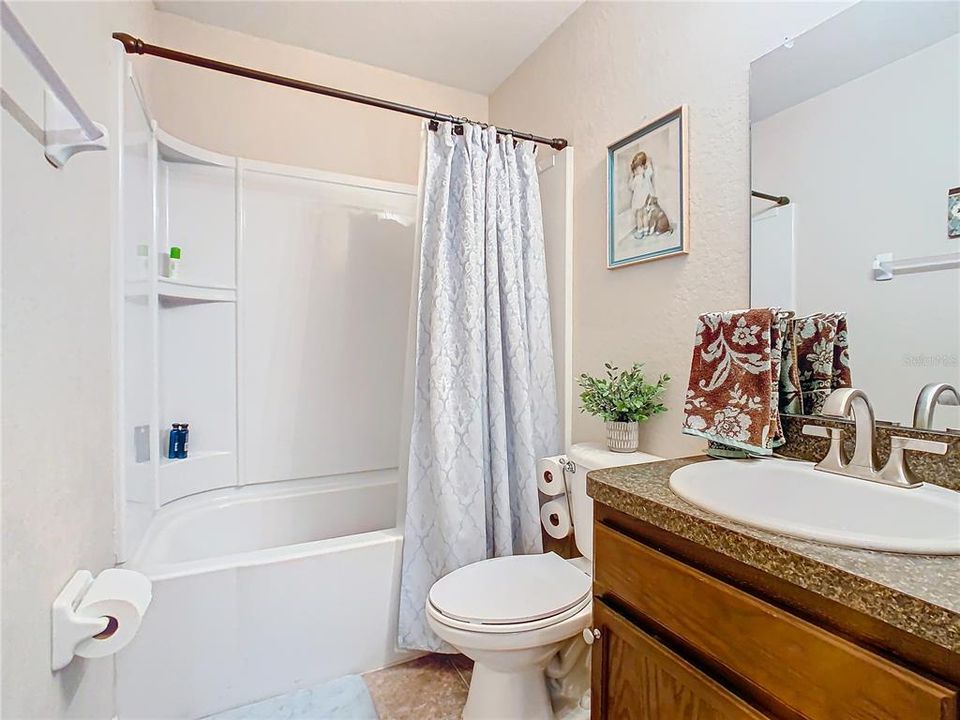 Guest bathroom has tub/shower combination