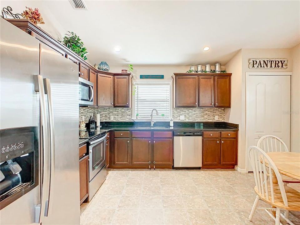 Wood cabinets, granite counter tops, stainless steel appliances and pantry.