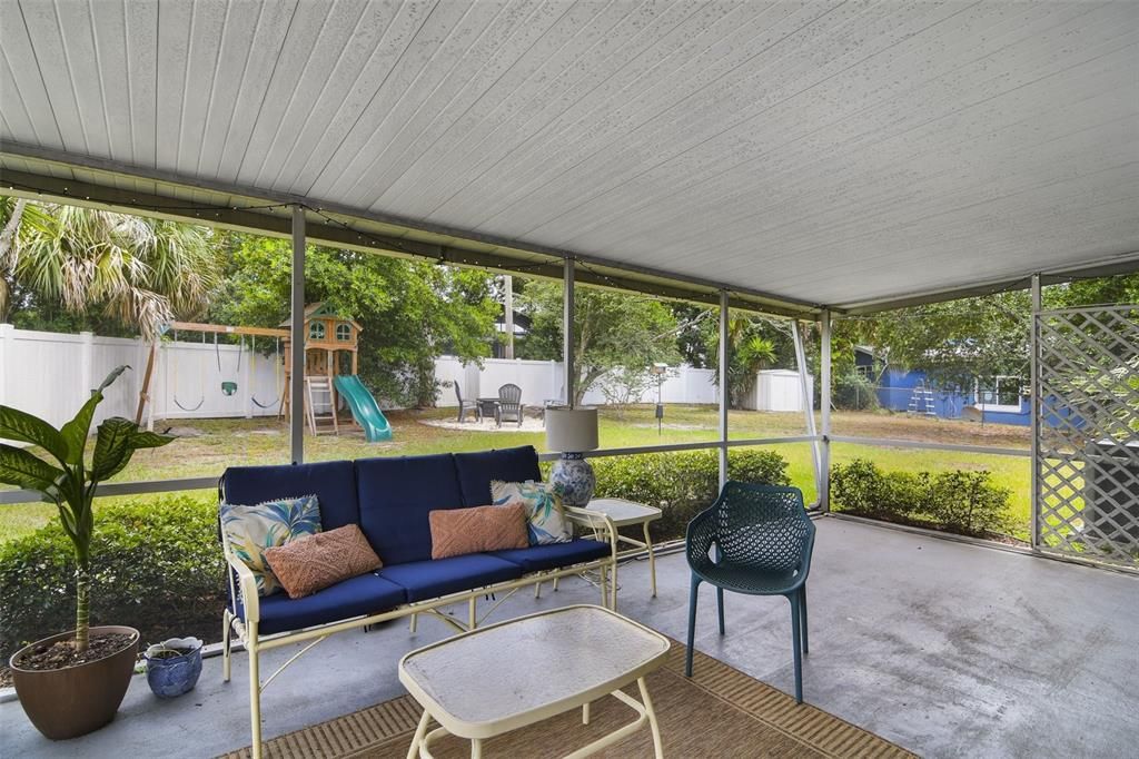 A spacious SCREENED LANAI overlooks a sprawling FENCED YARD surrounded by mature trees for the perfect blank canvas to create the outdoor oasis of your dreams.