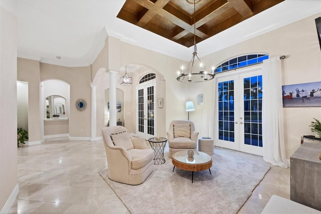 Dining Room with Decorator Coffered Ceiling and French Doors to courtyard (shown as a living space)