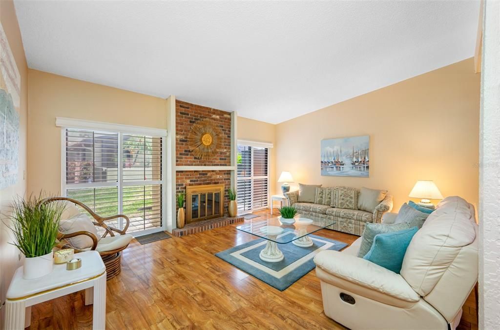 Living room with wood burning fireplace and backyard access