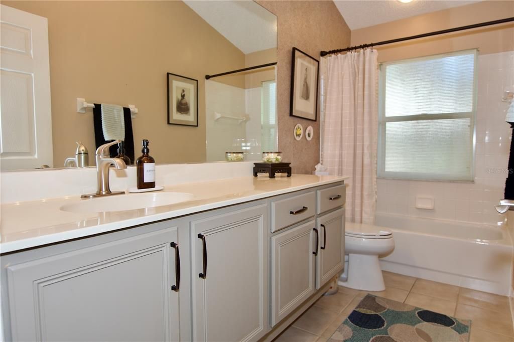 Large Guest Bathroom with linen closet behind the door