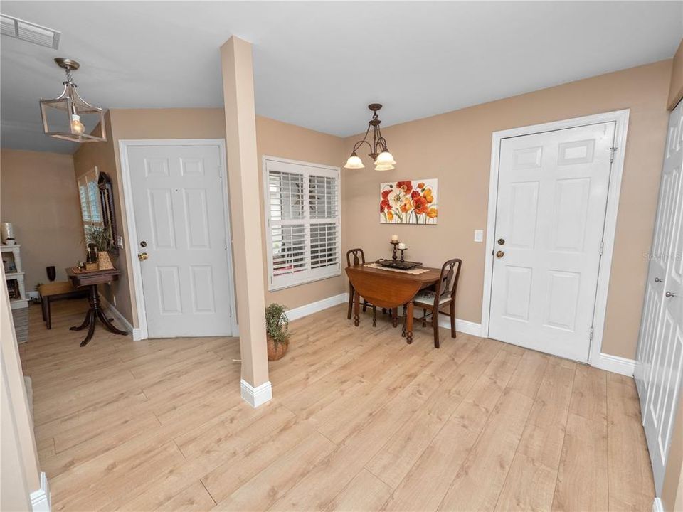 Laundry area with washer dryer off kitchen leading into garage area