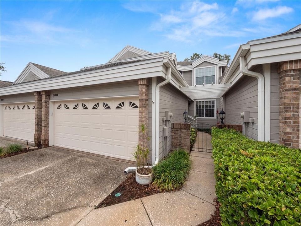 Front View of condo with 2 car garage