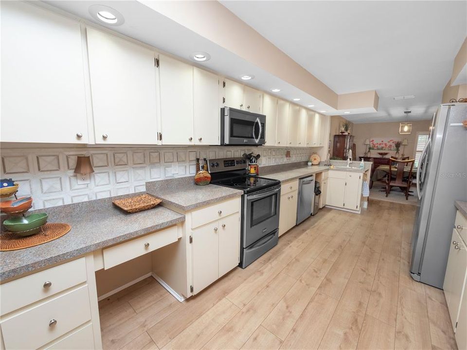 The kitchen has ample cabinet space and updated stainless steel appliances