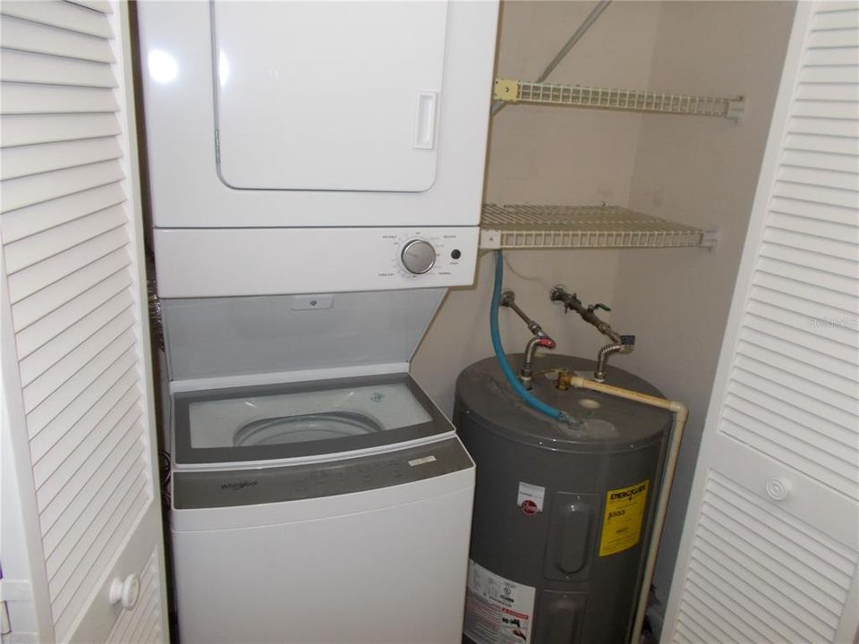 Washer/dryer combo and water heater in a closet in the kitchen.