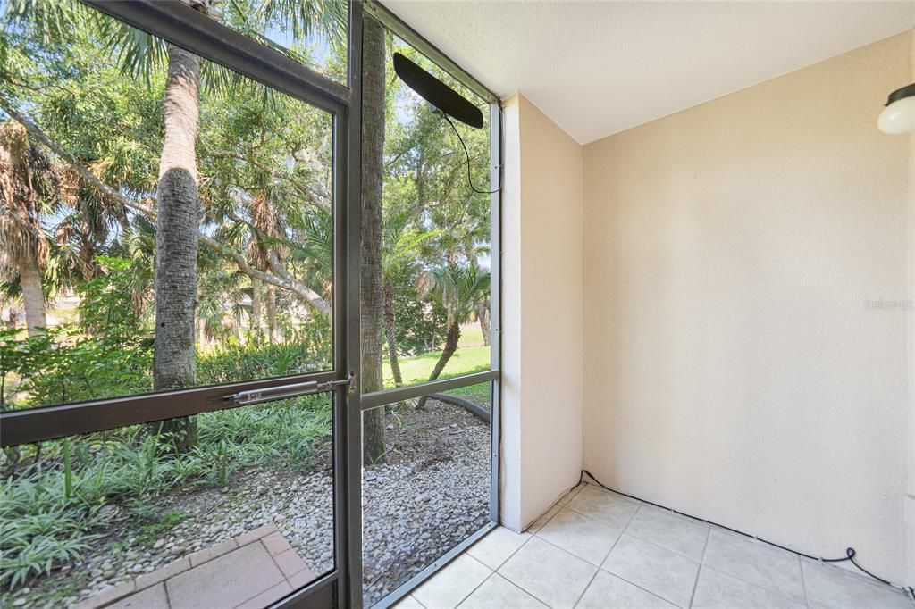 Screened lanai with tranquil setting of green space!