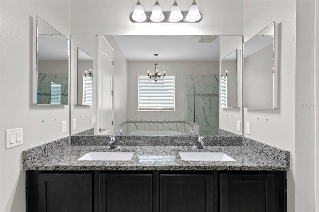 The large master bath includes granite counters and dual sinks