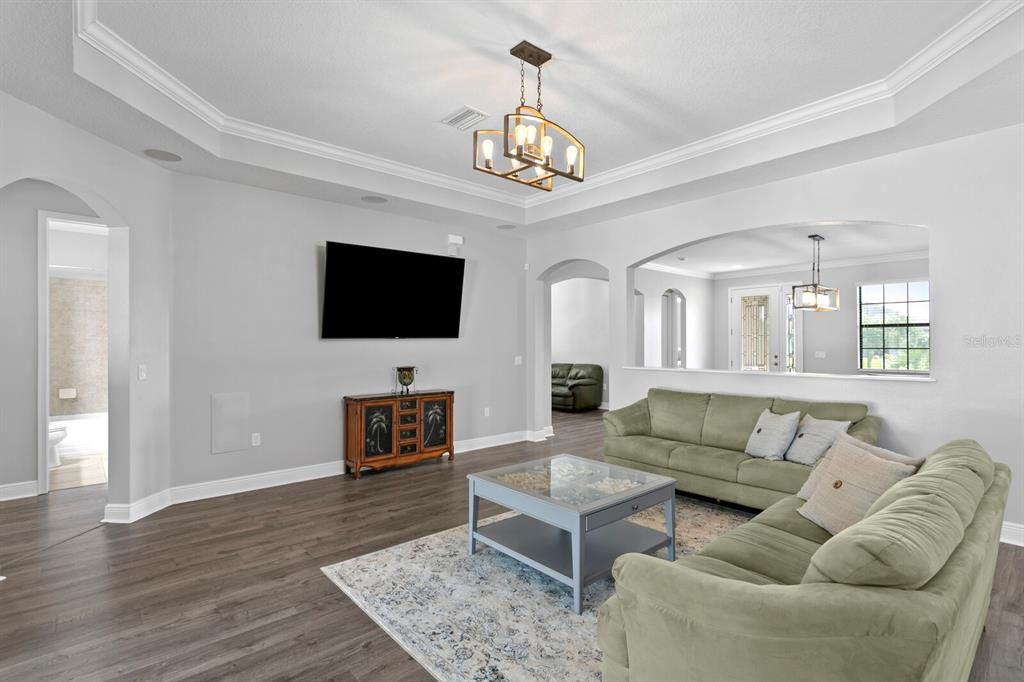 The large family room features a tray ceiling