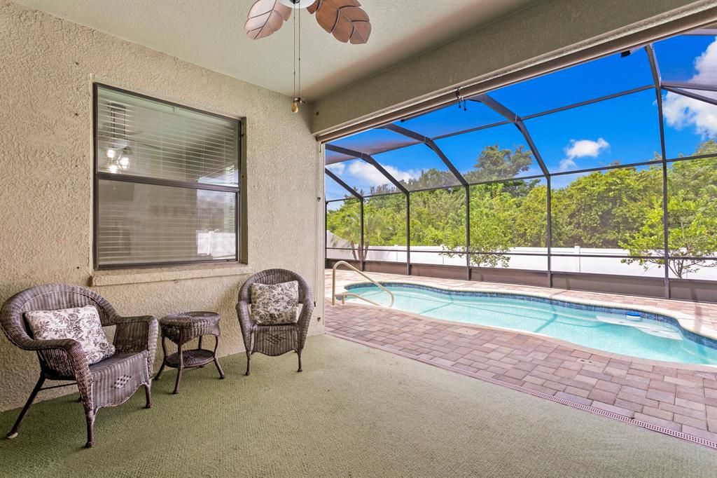 Relax under the fan on your covered lanai next to your private pool