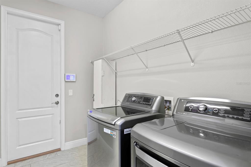 The oversized laundry room includes the washer/dryer and washtub and leads out to the 3-car garage