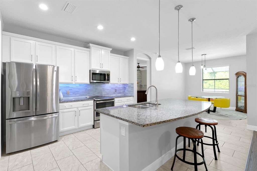 The kitchen includes a large island and updated stainless appliances