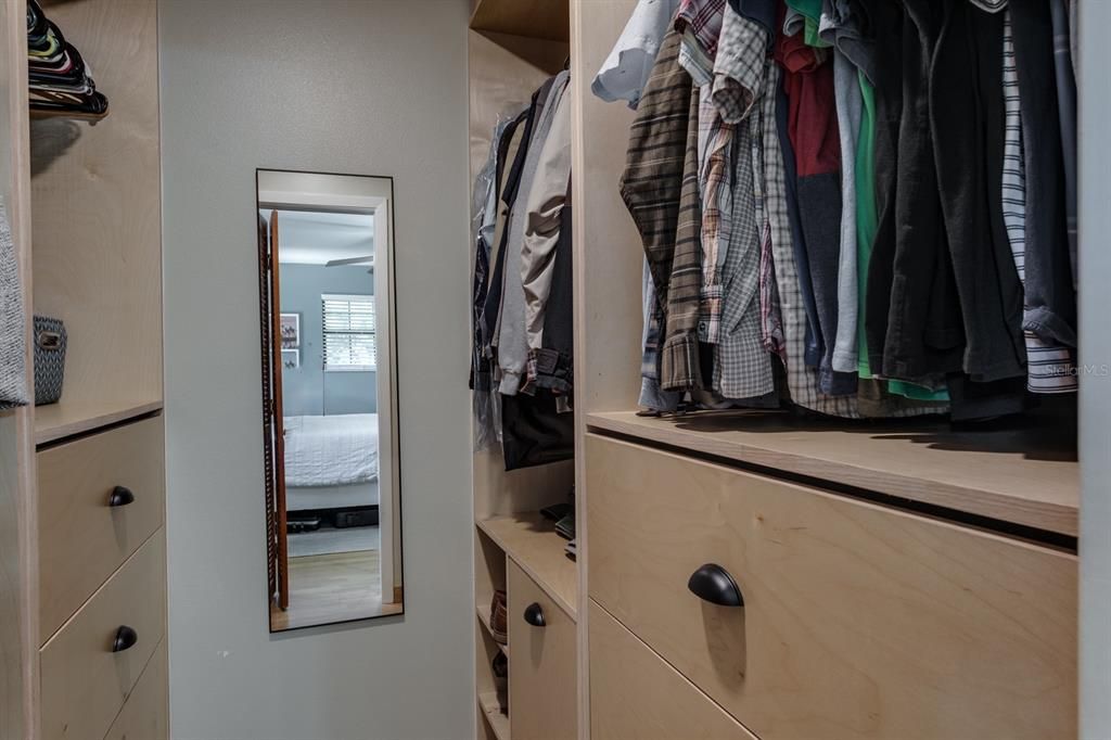 primary walk-in closet with custom built-ins
