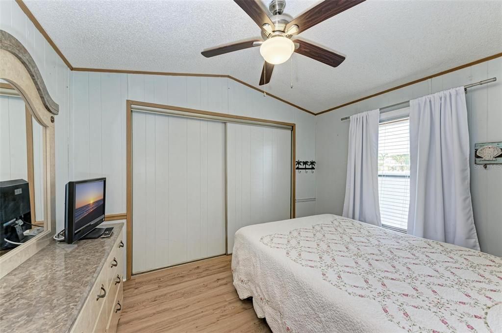 Guest bedroom has large closet and vinyl plank flooring