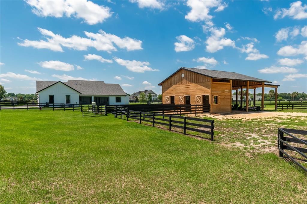 Back of the home and 3-stall horse barn