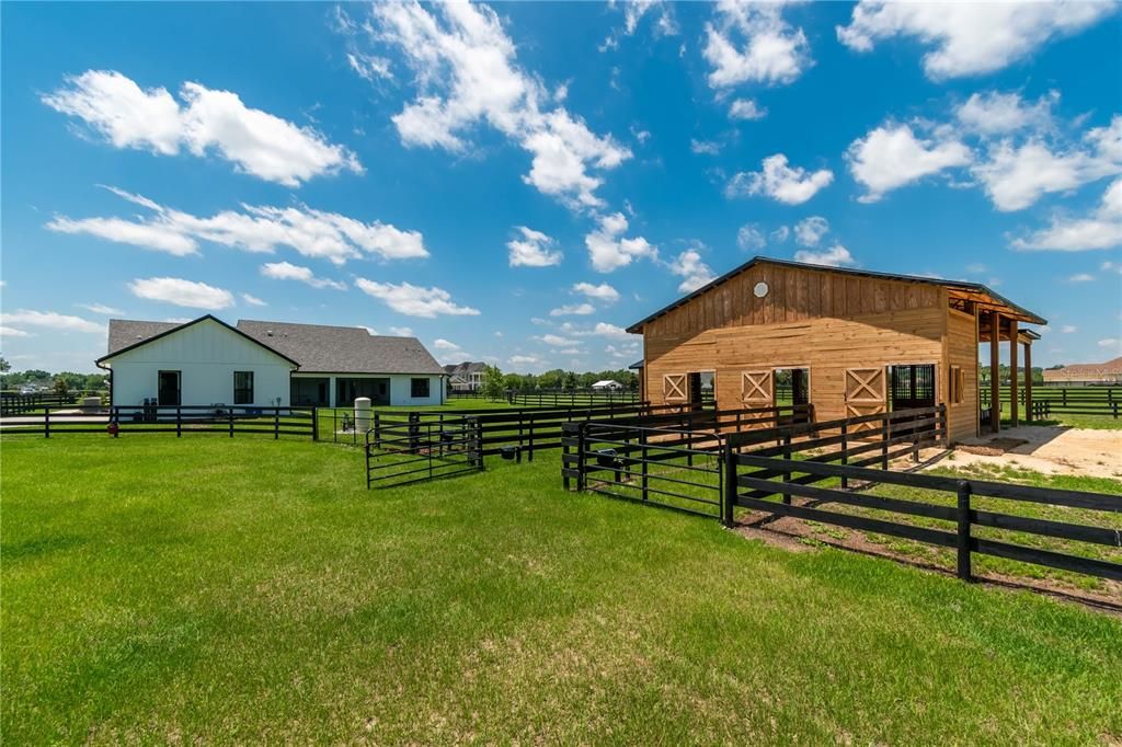 Back of the home and 3-stall horse barn