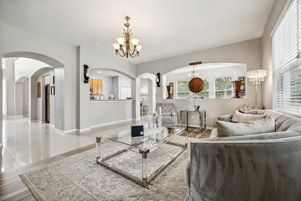 A more perfect gathering space does not exist with your family room featuring another large window for a view of the pool and backyard, a passthrough/breakfast bar into the kitchen and connection to the formal dining room.