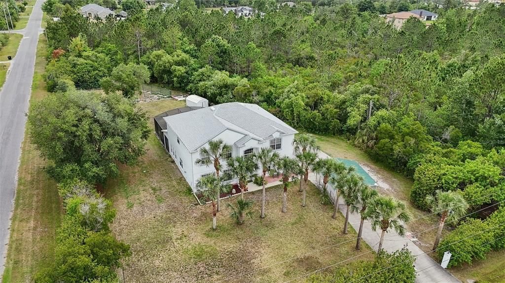 Welcome to East Orlando’s Wedgefield community and this spacious 6-bedroom, 3-full bath POOL HOME on a 1.03 ACRE/CORNER LOT with a NEW ROOF (2023), FRESH PAINT, formal, family and FLEX SPACE for plenty of room to grow!