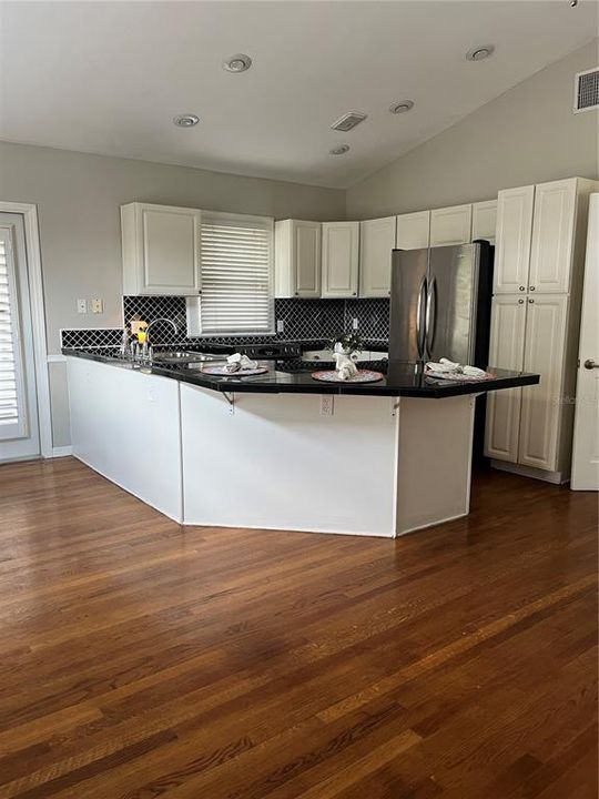 Kitchen view standing in front of back french doors to deck