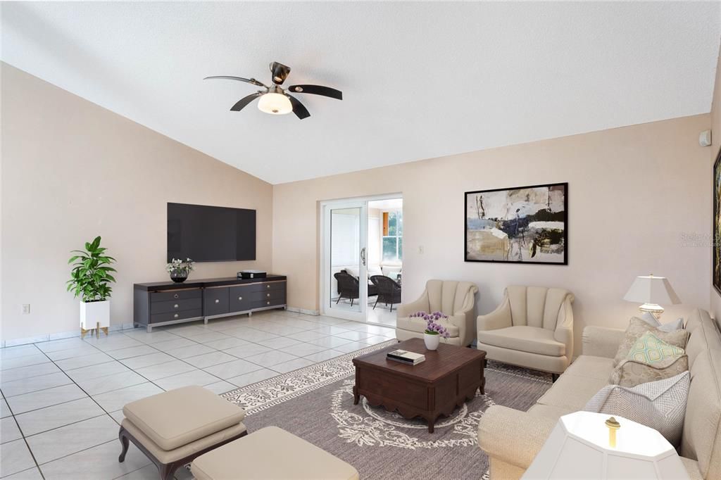 The foyer opens up to a spacious EAT-IN KITCHEN and the living room beyond where HIGH CEILINGS add to the bright open feel and sliding glass doors give you access to a large FLORIDA ROOM for additional flexible space.