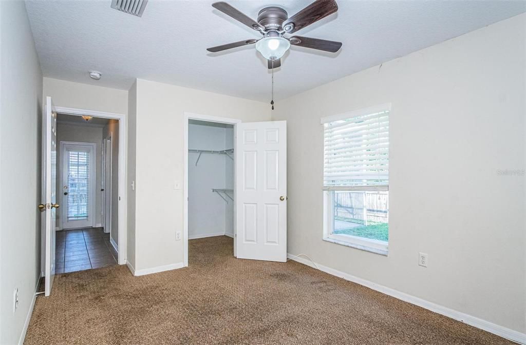 4th bedroom with adjacent pool bathroom and walk-in closet