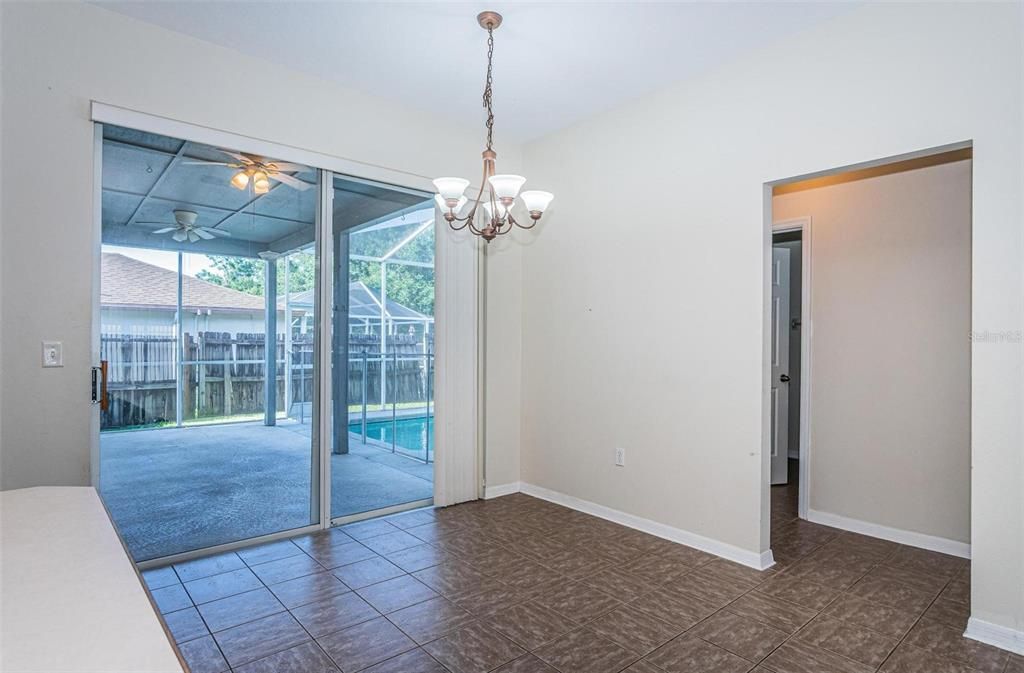 Breakfast nook has sliders to the lanai and pool