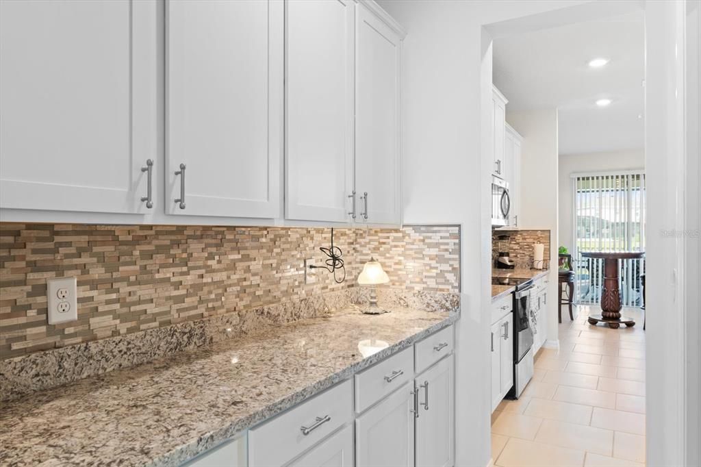 The butler's pantry - generous Shaker cabinet and drawer space, and beautiful backsplash to complement the granite.