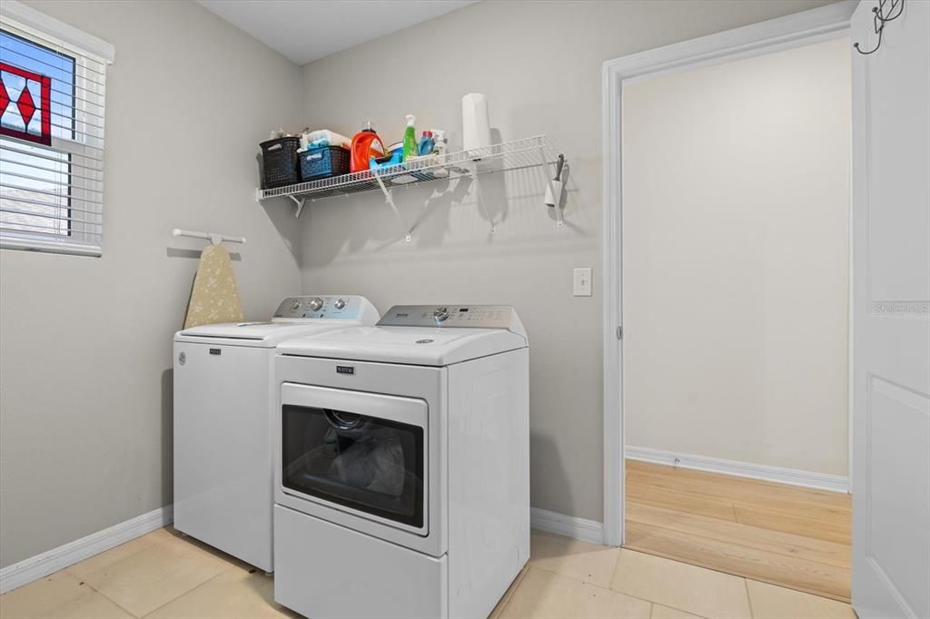 Spacious laundry room, connects to both primary closet and hallway - so convenient!
