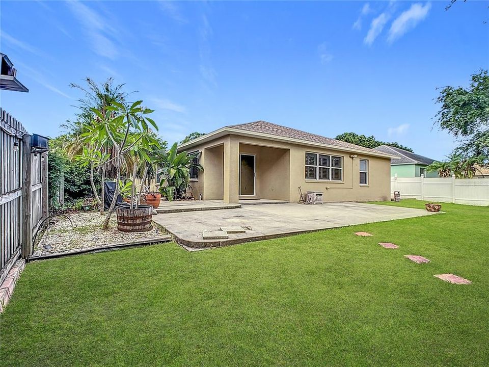 Charming backyard boasts an oversized 13x33 rear concrete patio, ideal for entertaining family and friends.