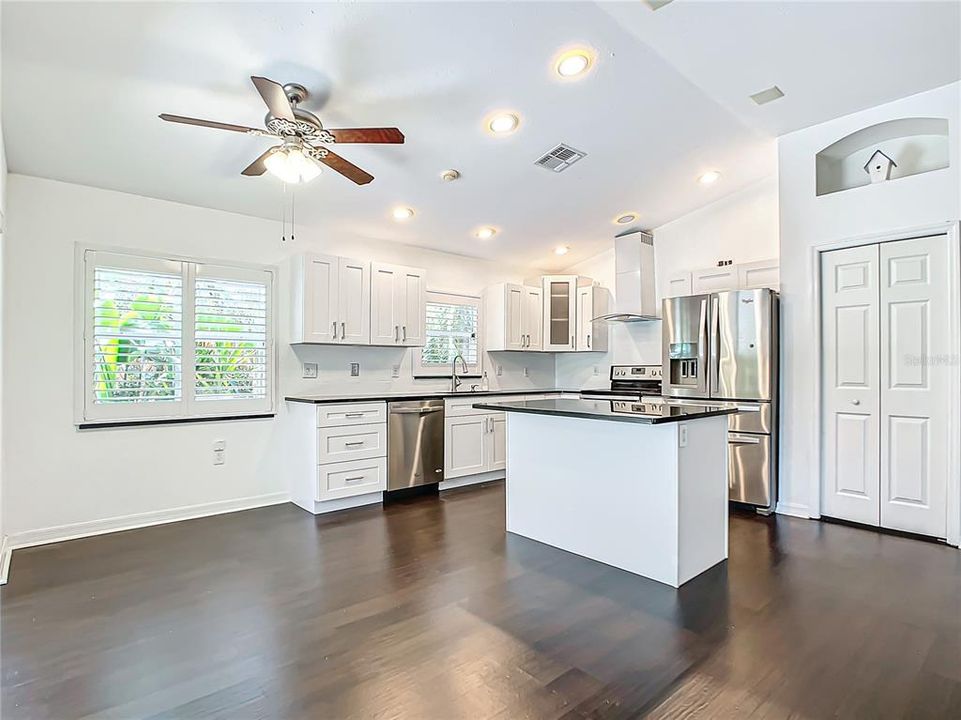 Centralized kitchen; which was recently updated in 2020, features stainless-steel appliances, granite countertops, hardwood cabinets with soft close, a breakfast bar, and a dry bar with additional cabinets for added storage.