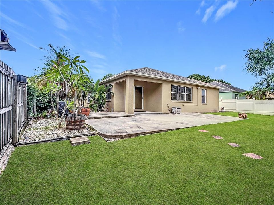 Charming backyard boasts an oversized 13x33 rear concrete patio, ideal for entertaining family and friends.