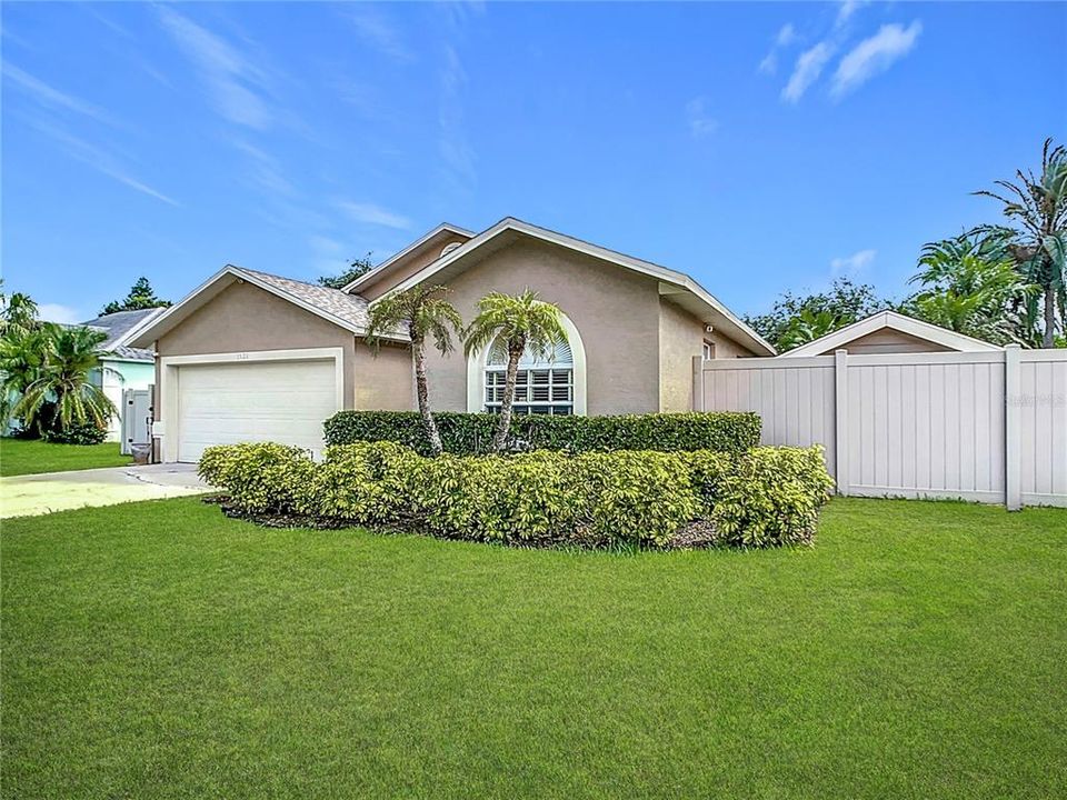 Front of home with mature landscaping.