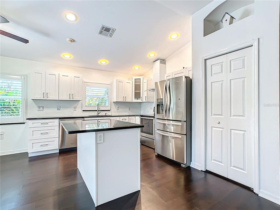 Centralized kitchen; which was recently updated in 2020, features stainless-steel appliances, granite countertops, hardwood cabinets with soft close, a breakfast bar, and a dry bar with additional cabinets for added storage.