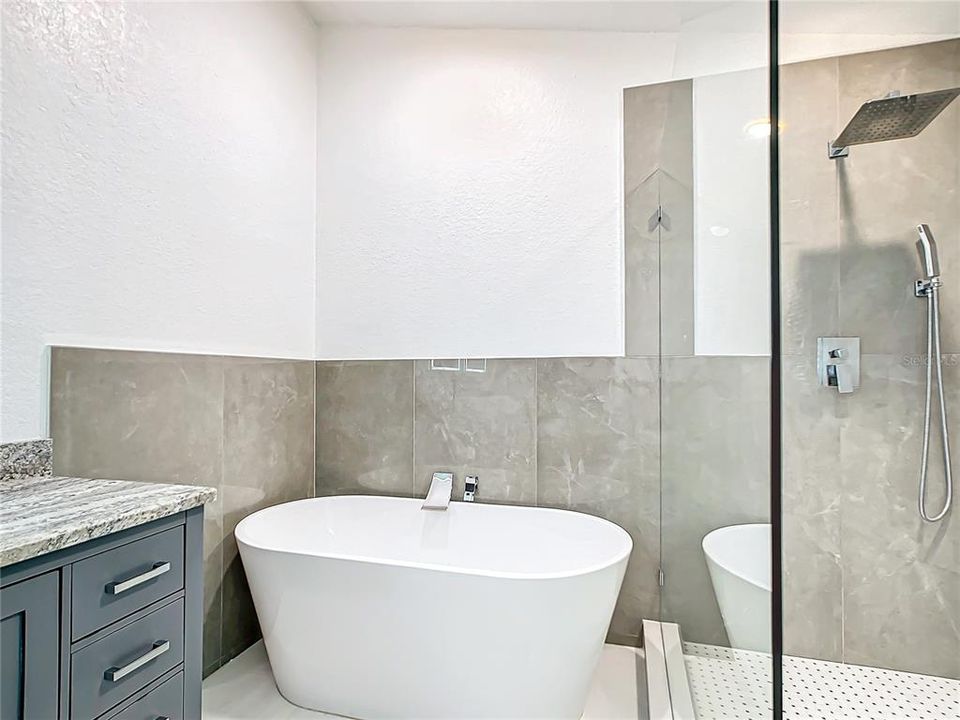 The En-suite primary bathroom has been beautifully remodeled with a soaking tub and separate shower.