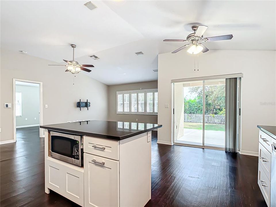 Sliding glass door opens to a charming backyard.