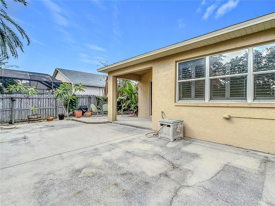 Charming backyard boasts an oversized 13x33 rear concrete patio, ideal for entertaining family and friends.