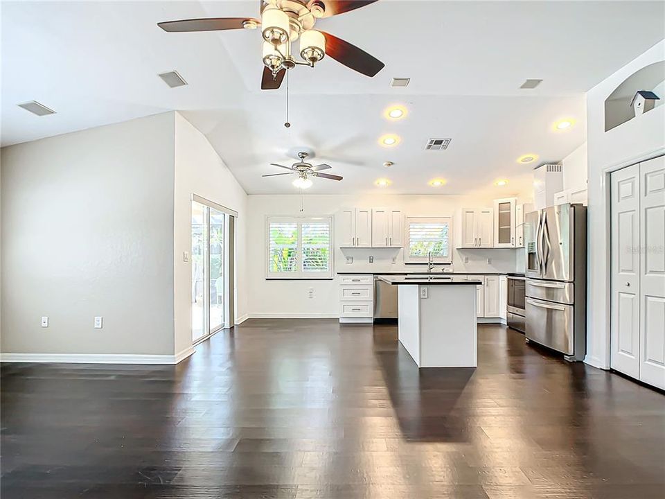 Centralized kitchen; which was recently updated in 2020, features stainless-steel appliances, granite countertops, hardwood cabinets with soft close, a breakfast bar, and a dry bar with additional cabinets for added storage.