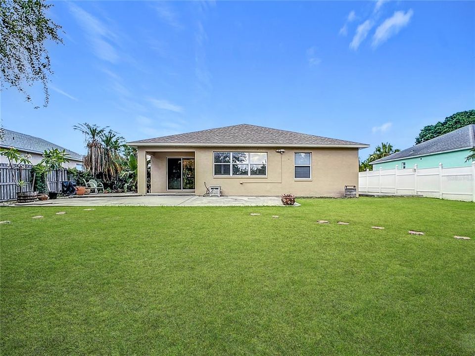 Charming backyard boasts an oversized 13x33 rear concrete patio, ideal for entertaining family and friends.