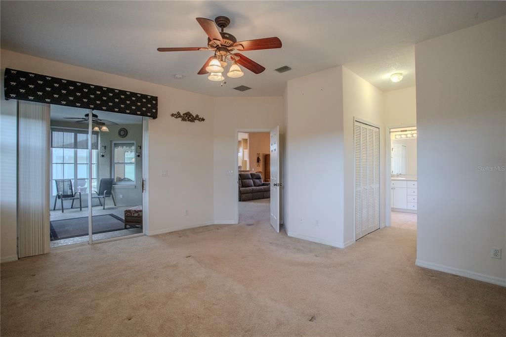 Primary Bedroom with sliding door access to enclosed Lanai