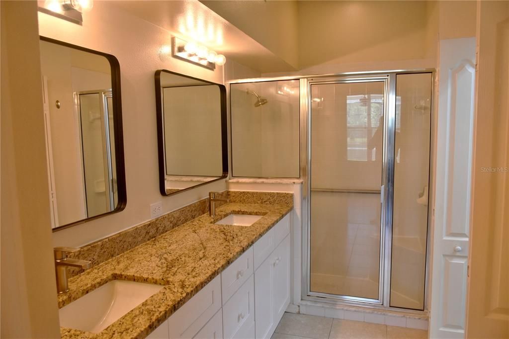 Master bath with new cabinets, dual sinks, and granite counters