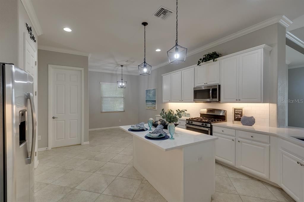 Gourmet Kitchen is Equipped with Stainless Steel Appliances, Gas Stove, Quartz Counters, 42" Cabinets and Pendant Lighting.