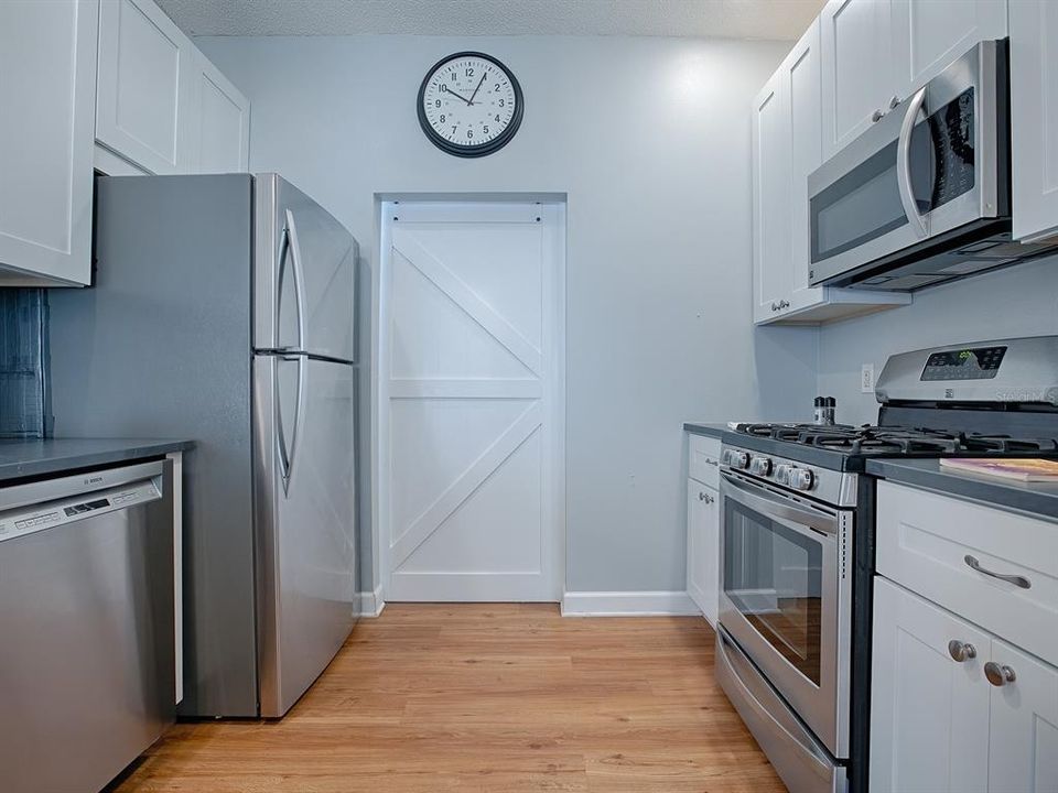 Cute barn door that takes you to the inside laundry and large pantry